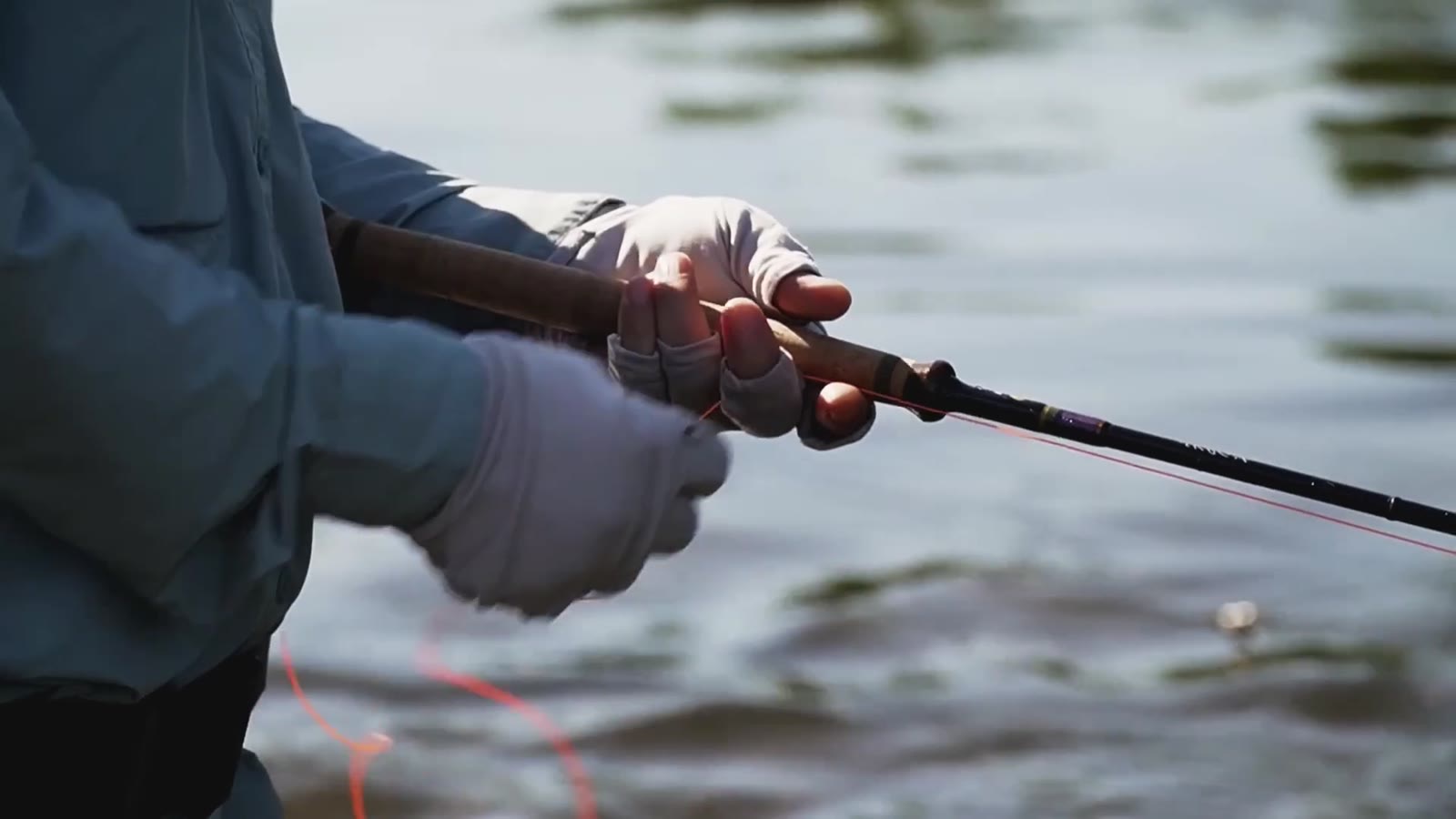 Close view of an angler working with a fishing rod