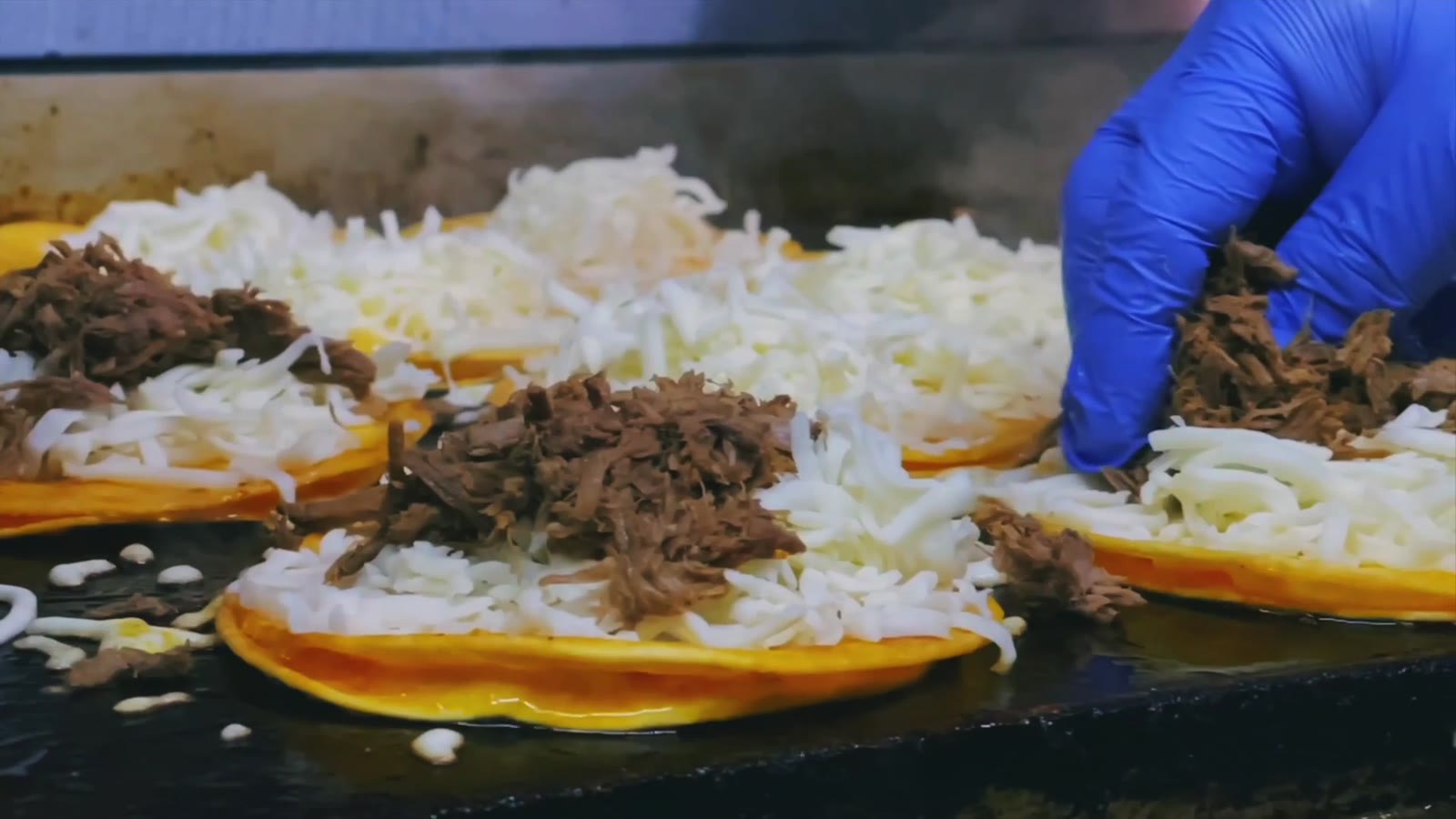 Hands assembling food during active restaurant service